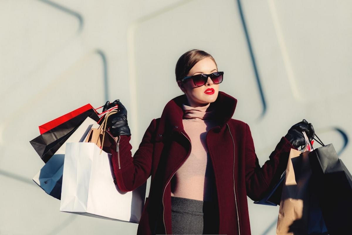 A bustling shopping street with a mix of designer boutiques, local markets, and street performers, capturing the vibrant atmosphere of shopping districts.