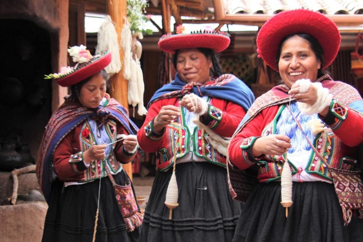 local community tours A group of tourists participating in a local craft workshop, with colorful artifacts and smiling locals in a lively market scene.
